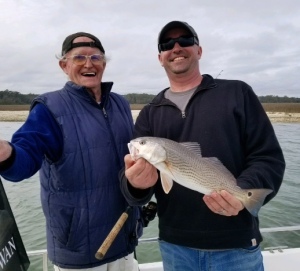 Andrew Farr and his father in law with a schoolie redfish.