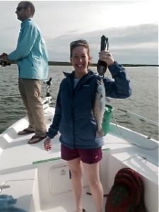 Stephanie Yost with a large seatrout. Her husband Mark is in background.