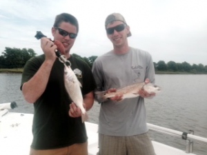 Ralph Lattke with a 2 lb. croaker and James Mulford with nice schoolie red!