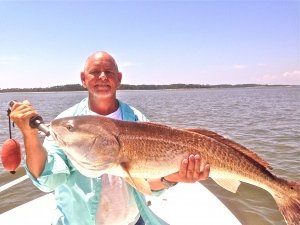 Capt. Jack on a sunny day with a large red drum!