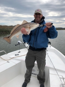Luke Myles with a large redfish with a fish at the end of th day.