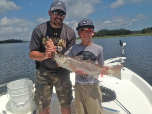 Dave Schumacher and his son Evan with a 25 inch redfish