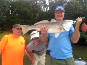 John Drawdy with a large redfish! John Gross in yellow t shirt, Tony Tuttle looking through. Nice to wrap up a nice day of fishing!