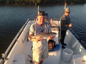 Mike Savage with a nice redfish! Angela is in the background with her red on the deck of the boat! Good fishing!