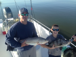 Michael Morris and son with a couple of nice fish! Michael has red while his son Christian is holding a black drum. Nice catching!