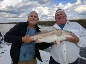 Capt. Jack & John Weathers with a 32 inch redfish.