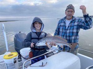 Young fisherman with a nice red!  Capt. Jack is in the background.