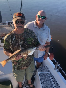 Jimmy with a nice red.  Capt. Jack is in the background.