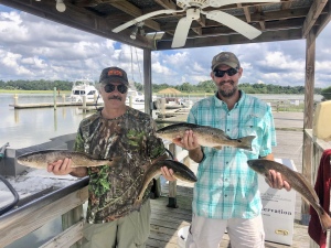 Jimmy & Isacc Pague catching some reds on a hot summer day.